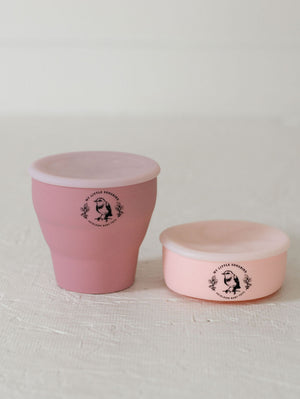 Collapsible silicone snack cups in vibrant colors, perfect for on-the-go baby snacks.