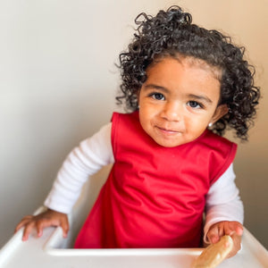 Solid cranberry minimalist bapron for babies, showcasing a stylish and functional design from angle 2.