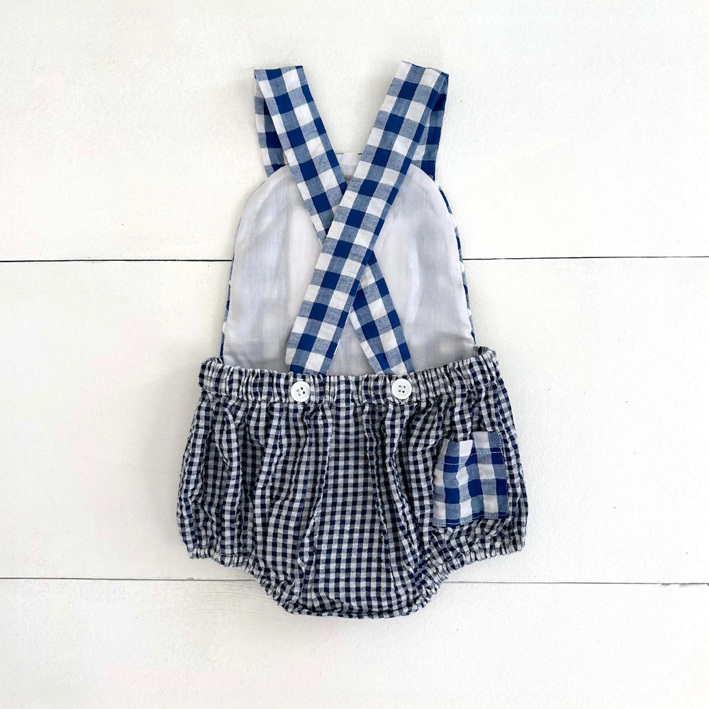 Navy blue smocked sunsuit for baby boys, perfect for first birthday celebrations.