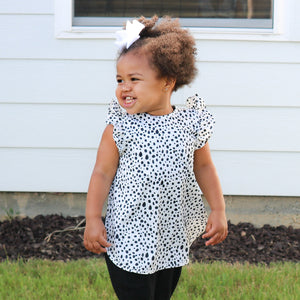 Organic Dot Flutter Bapron for babies, featuring a playful dot design, angled view showcasing its unique style and comfort.