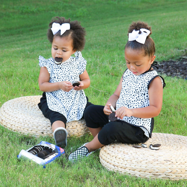 Organic Dot Flutter Bapron for babies, featuring a playful design and comfortable fit, angled view.