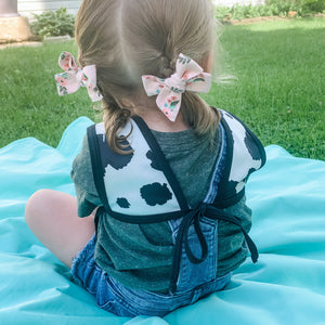 Cowhide Bapron on sale, angled view showcasing its unique design and functionality for babies.