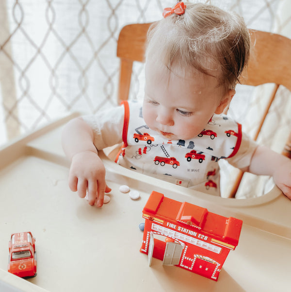 "Be Brave Firefighter Bapron for babies, featuring a fun design, perfect for mealtime messes."