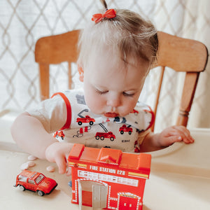 "Be Brave Firefighter Bapron for babies, angled view showcasing fun design and practical use."
