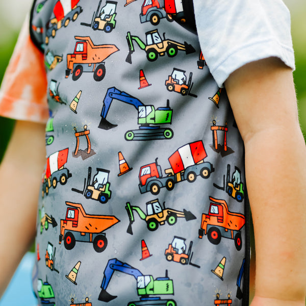 "Construction Zone Bapron for babies, featuring playful construction-themed design, perfect for mealtime messes."