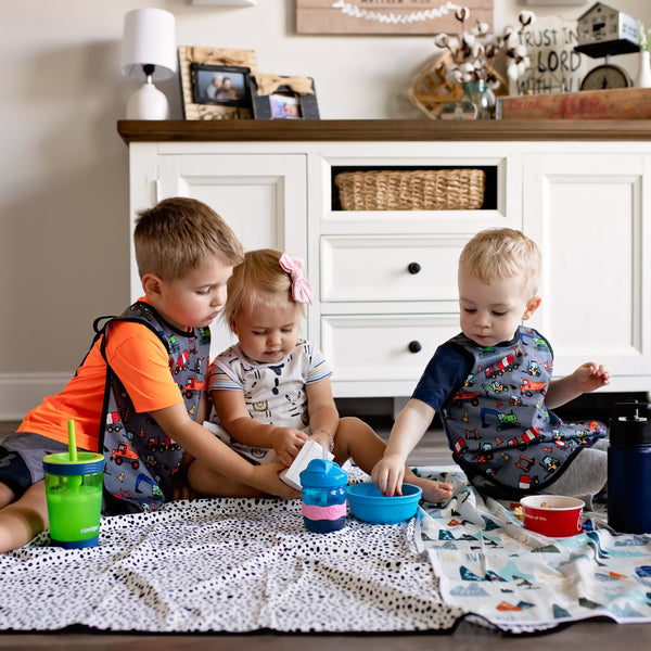 "Construction Zone Bapron for babies, featuring playful construction designs, perfect for mealtime messes."
