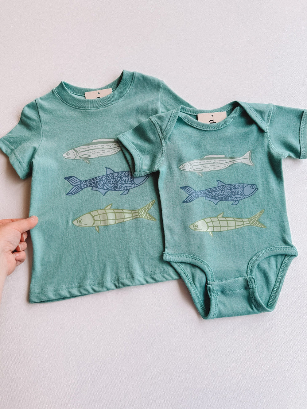 Catch + Release short sleeve onesie for babies, featuring a cute design and soft fabric for comfort and style.