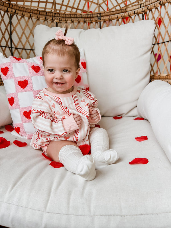 Laced with Love Sweatshirt Romper for babies, showcasing cozy style and comfort from an angled view.
