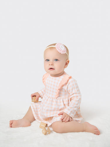 Organic cotton ruffled dress in pink gingham for babies and toddlers, perfect for stylish and comfortable wear.