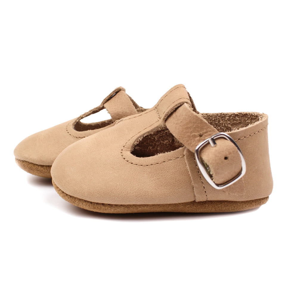 Tan T-Strap Mary Jane soft sole baby shoes - stylish and comfortable for little feet.