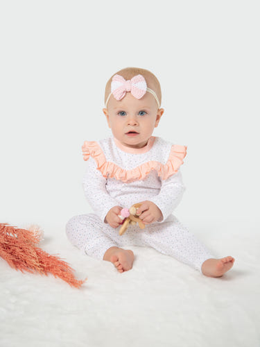 Organic cotton ruffled tee in polka dots for babies - soft, stylish, and eco-friendly. Perfect for everyday wear!