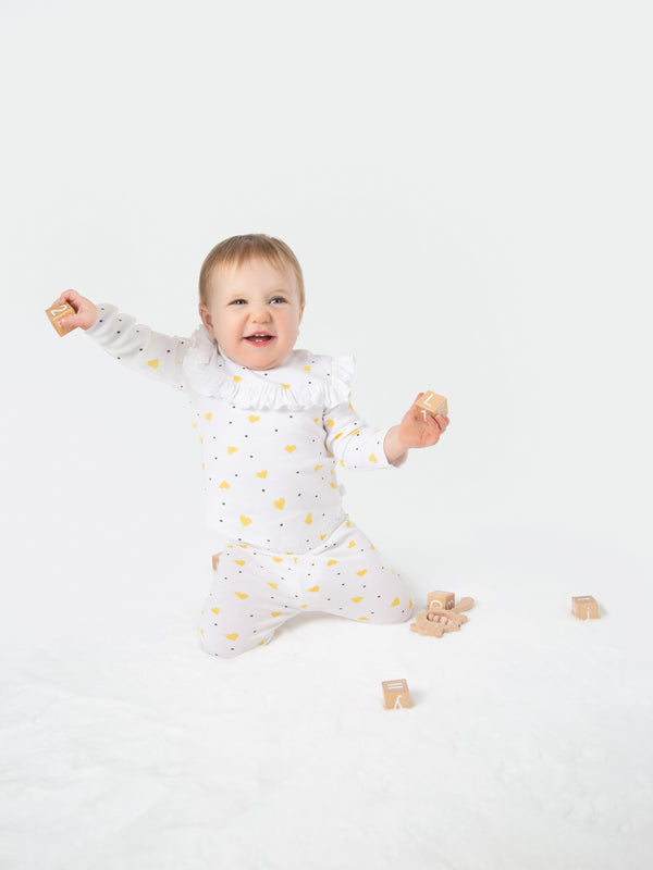 Organic cotton leggings in yellow hearts design for babies, soft and comfortable for everyday wear.