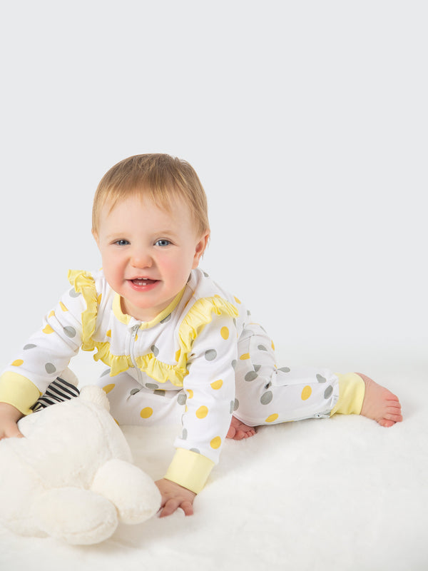 Organic cotton yellow and gray polka dot ruffled romper for babies, perfect for stylish comfort.