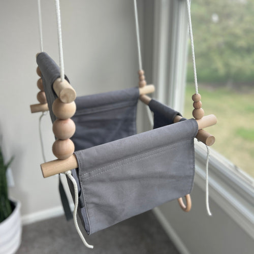 Gray indoor baby swing at angle 6, perfect for soothing and entertaining your little one.