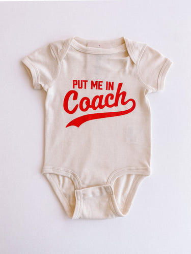 "Put Me In Coach short sleeve onesie for babies, perfect for playful and sporty outfits."
