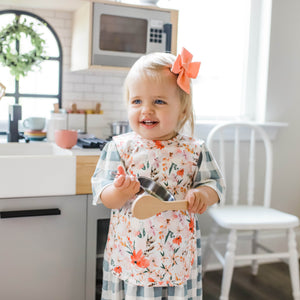 Peachy Dreams Bapron for babies, stylish and functional, shown at a 10-degree angle. Perfect for mealtime messes.
