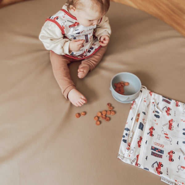 "Be Brave Firefighter Bapron for babies, featuring a fun design, perfect for mealtime messes and playtime adventures."