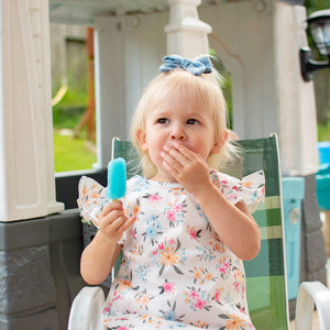Pastel Floral Flutter Bapron for babies, angled view showcasing its vibrant design and practical features.