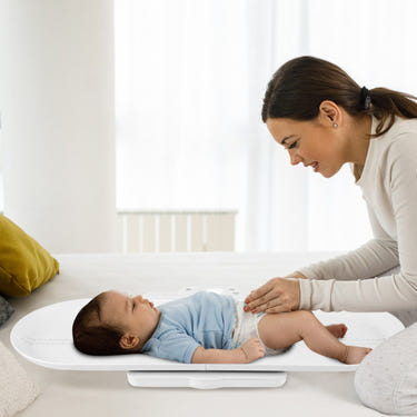 Infant scale with detachable tray for weight and height measurement in white, ideal for nursery furniture.