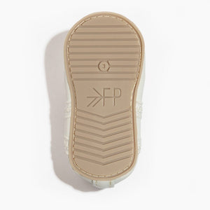 Ivory lace ballet slipper baby shoe, angle view showcasing delicate design and soft materials for little dancers.