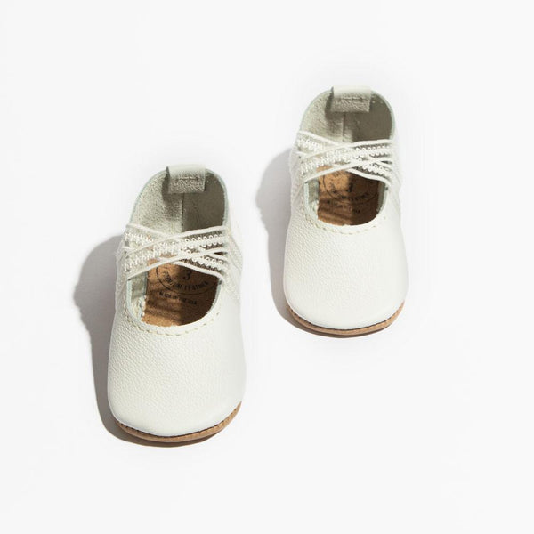 Ivory lace ballet slipper baby shoe, perfect for tiny dancers and special occasions.