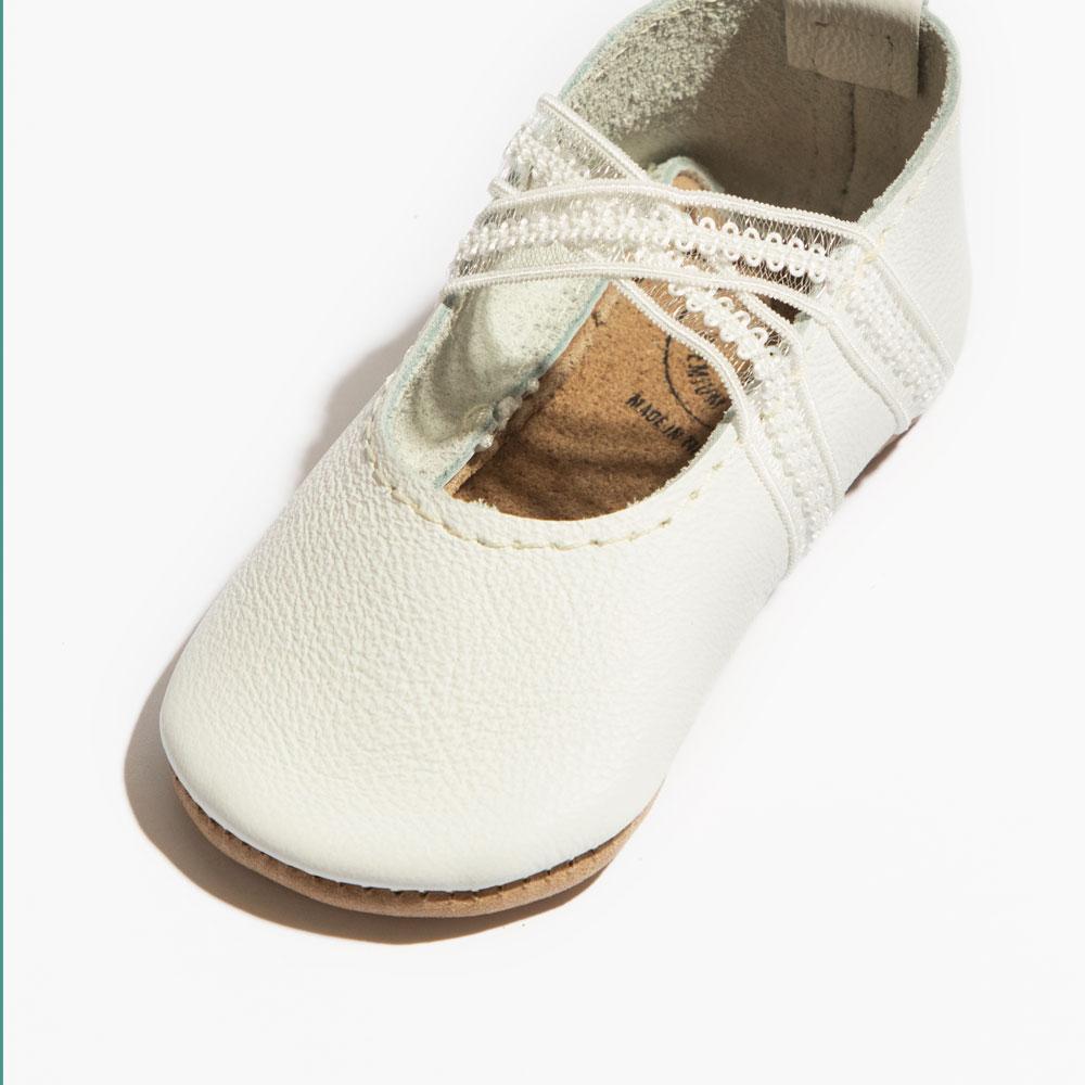 Ivory lace ballet slipper baby shoe, perfect for tiny dancers and special occasions.