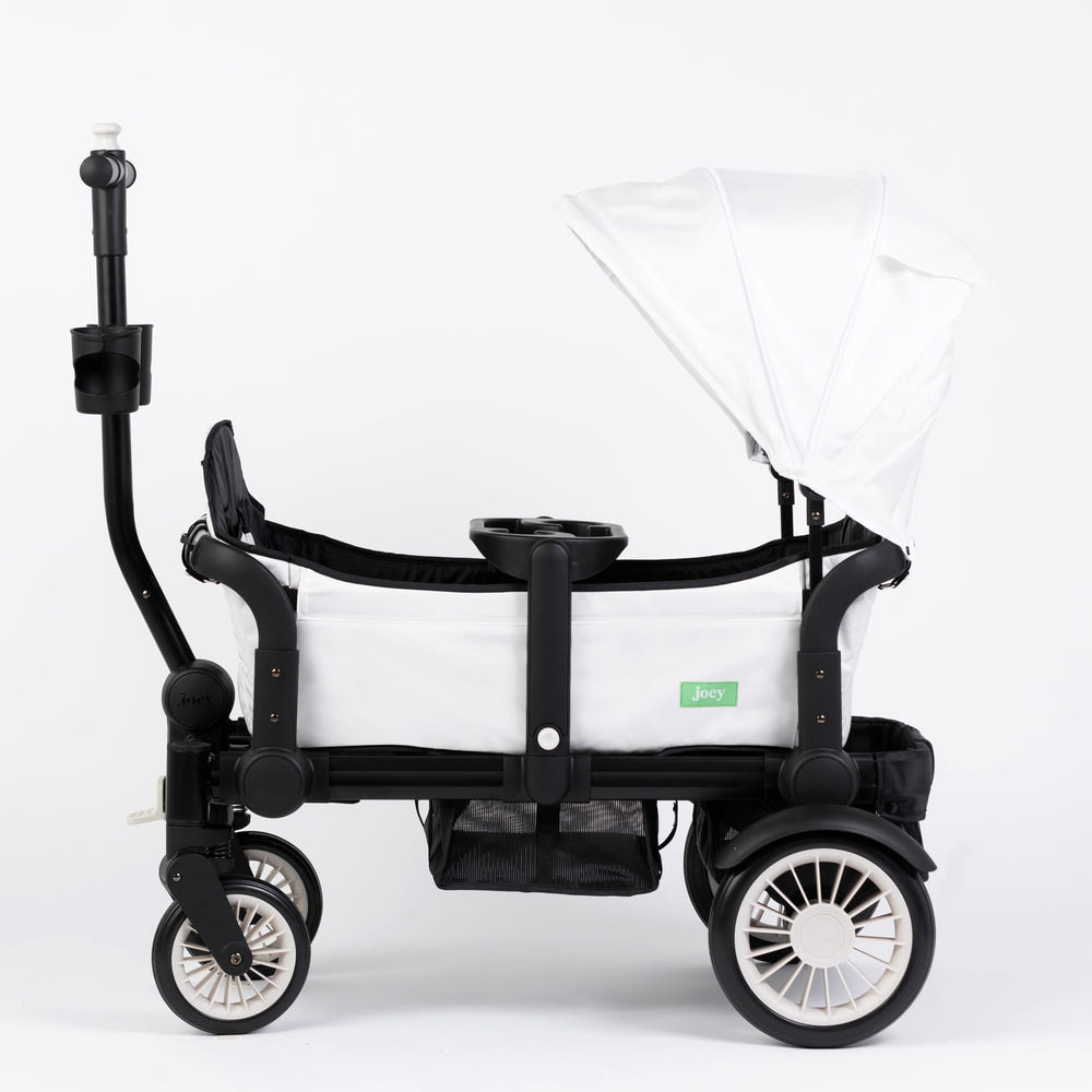 The Wagon Weekender White stroller wagon for babies, featuring a sleek design and spacious seating.