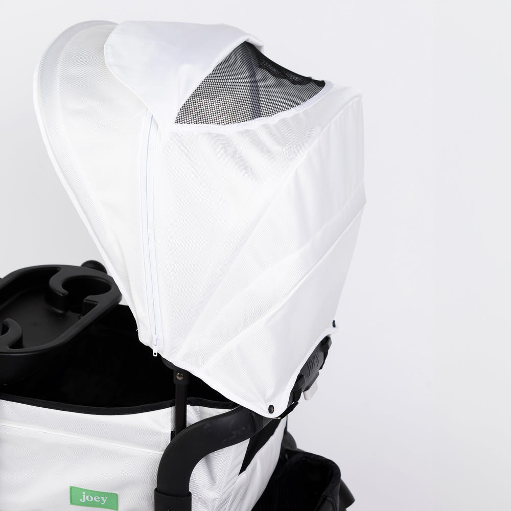White Weekender stroller wagon with two canopies, perfect for outdoor adventures with your baby.