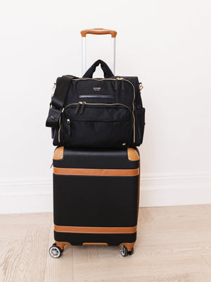 Black satchel diaper bag at angle 10, stylish and functional for parents on the go.