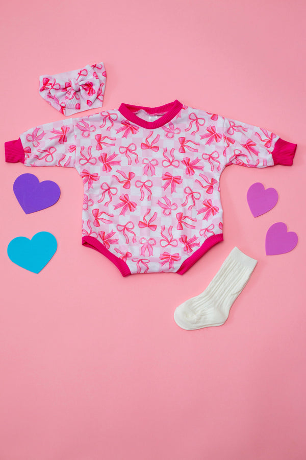Pink Bows Bubble Romper for babies, showcasing a cute design from an angled view. Perfect for stylish playtime!