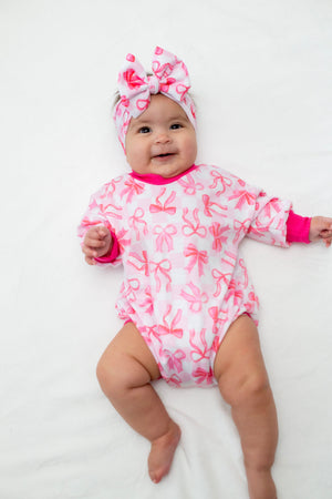 Pink Bows Bubble Romper for babies, perfect for stylish and comfortable playtime.