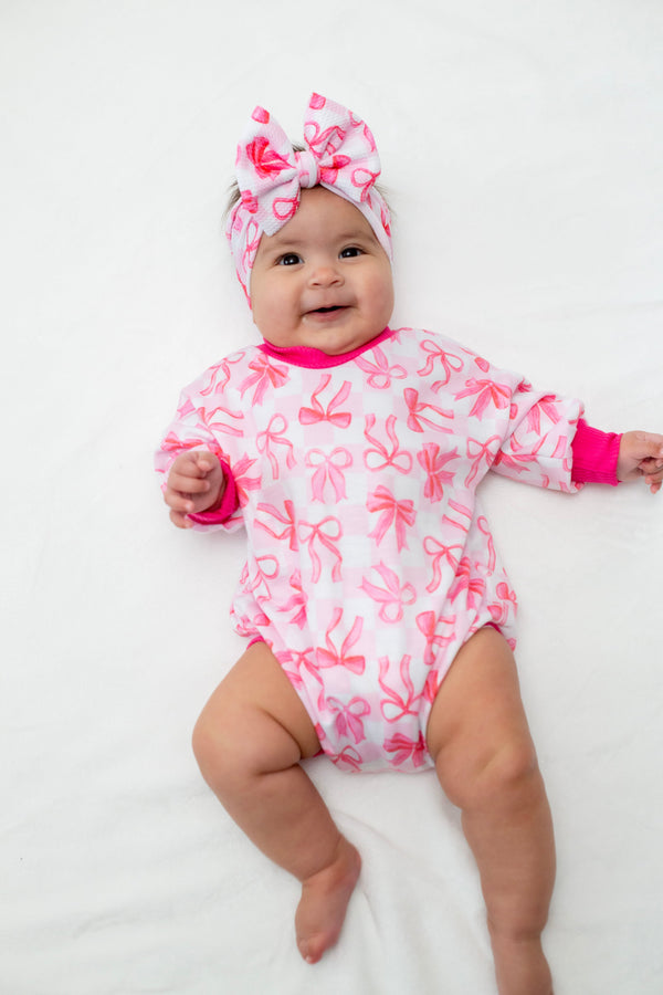 Pink Bows Bubble Romper for babies, perfect for stylish and comfortable playtime.