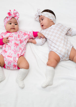 Pink Bows Bubble Romper for babies, featuring a cute design and comfortable fit, perfect for playful outings.