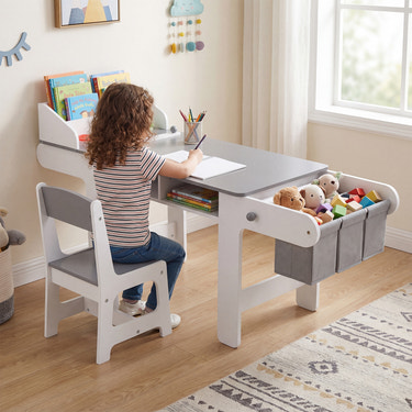 Kids art table and chair set in gray with paper roll and fabric bins for drawing, reading, and playing.