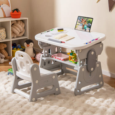 Height adjustable kids table and chair set with tiltable whiteboard and concave shelf in gray. Ideal for play and learning.