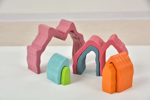 Colorful wooden mountain rainbow stacker toy puzzle blocks for indoor play at an angle view.