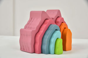 Colorful wooden mountain rainbow stacker toy puzzle blocks for indoor play, viewed at a 10-degree angle.