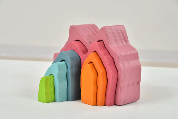 Colorful wooden mountain rainbow stacker toy puzzle blocks for indoor play, viewed at a 15-degree angle.
