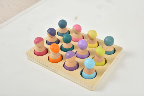 Colorful wooden rainbow peg dolls set of 12, perfect for indoor play and imaginative learning.