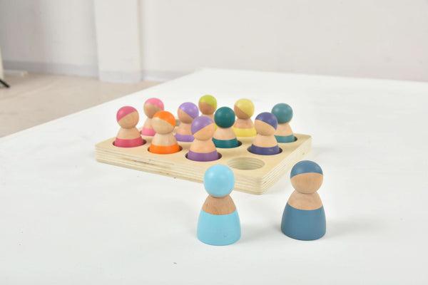 Colorful wooden rainbow peg dolls set, 12 pieces, perfect for indoor play and imaginative fun.