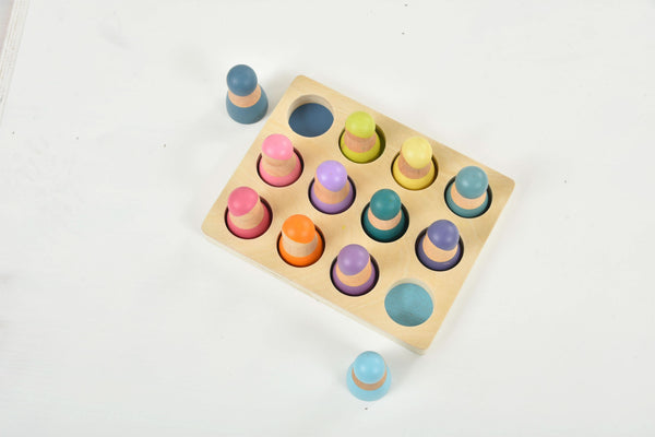 Colorful wooden rainbow peg dolls set, 12 pieces, perfect for indoor play and imaginative fun.
