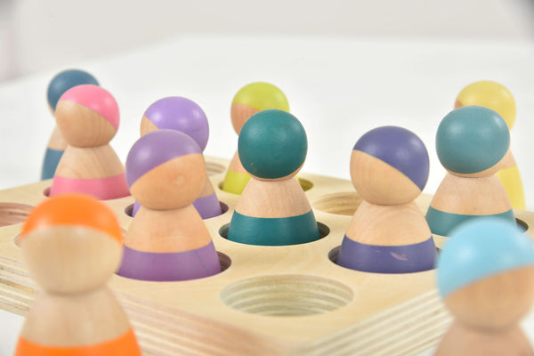 Colorful wooden rainbow peg dolls set of 12, perfect for indoor play and imaginative activities.