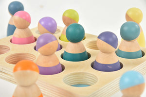 Colorful wooden rainbow peg dolls set, 12 pieces, perfect for indoor play and imaginative fun.