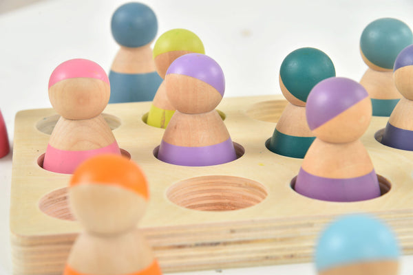 Colorful wooden rainbow peg dolls set of 12, perfect for indoor play and imaginative fun.