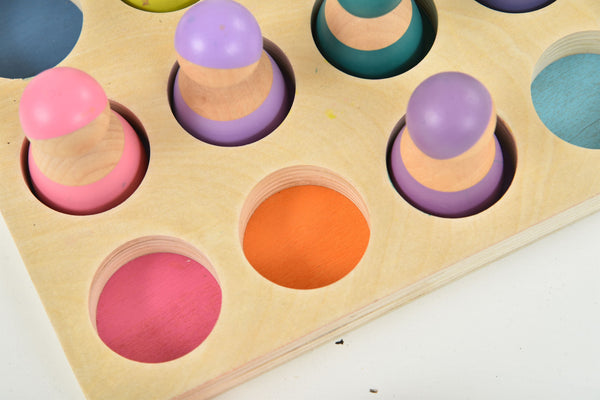 Wooden rainbow peg dolls set of 12, colorful figures for indoor play, displayed at an angle.