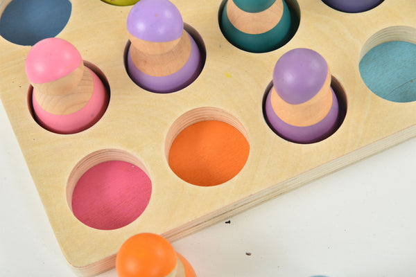 Colorful wooden rainbow peg dolls set of 12, perfect for indoor play and imaginative fun.