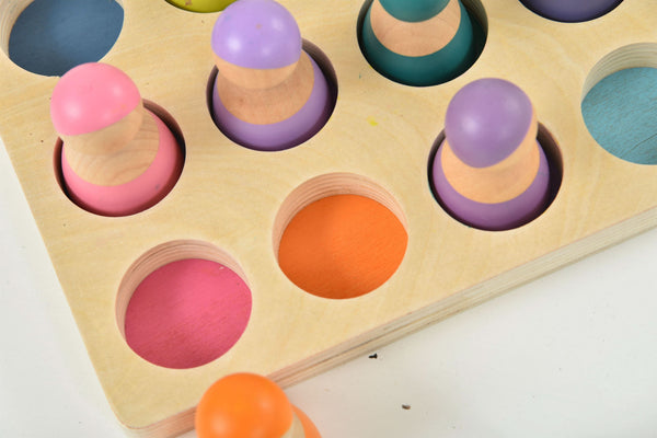 Colorful wooden rainbow peg dolls set, 12 pieces, perfect for indoor play and imaginative activities.