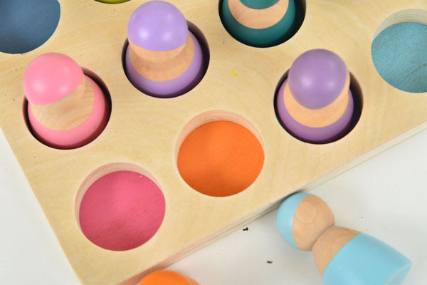 Colorful wooden rainbow peg dolls set, 12 pieces, perfect for indoor play and imaginative fun.