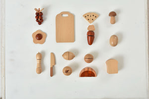 Colorful wooden play food sets for kids' kitchen, perfect for imaginative indoor play.