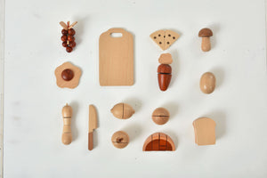Wooden play food set for kids' kitchen, featuring colorful pieces for imaginative indoor play. Angle 17 view.